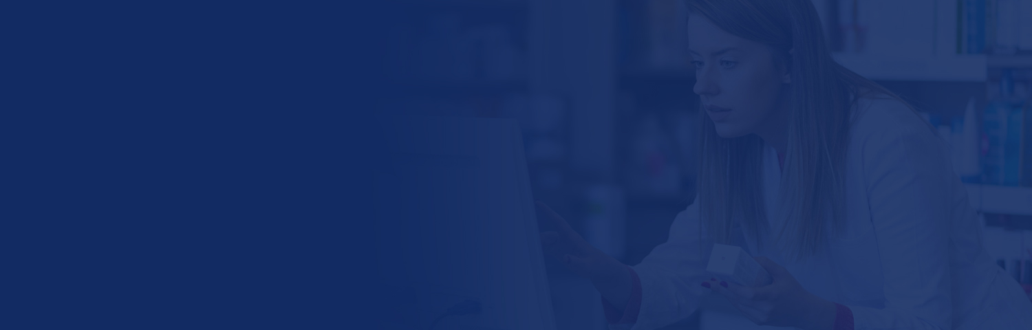 Pharmacist making prescription record through computer in pharmacy