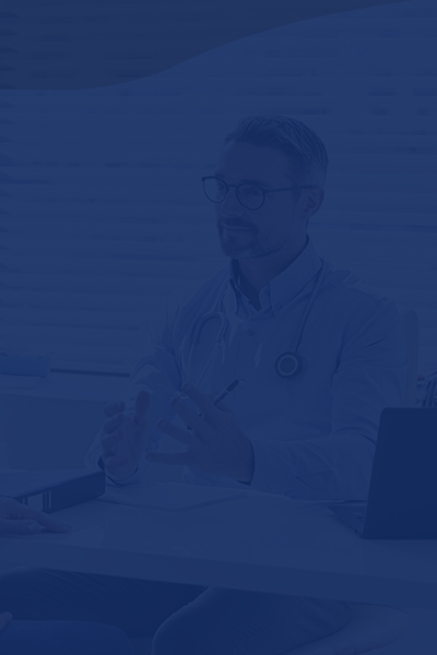 Patient with doctor sitting at desk for consultation