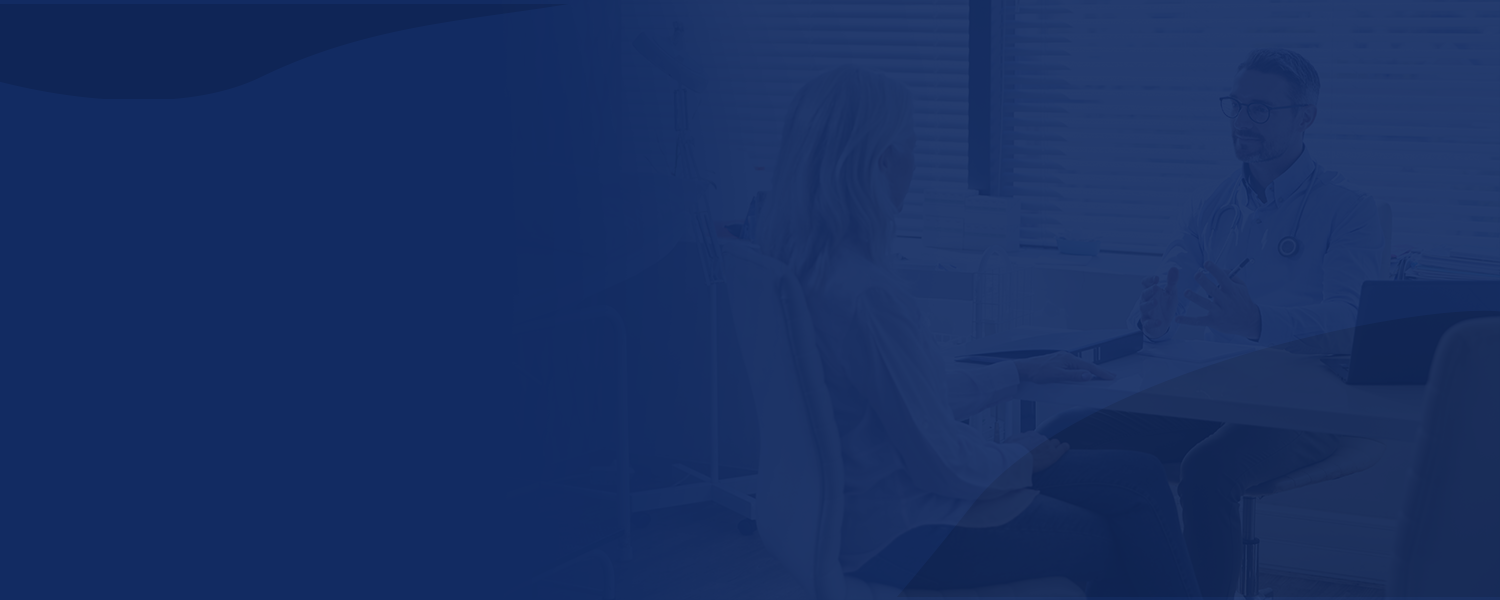 Patient with doctor sitting at desk for consultation